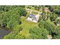 Aerial view of home with pool, pool house and grassy field at 2508 Kearney Rd, Wake Forest, NC 27587