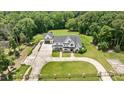 Wide aerial shot of property with a long drive, manicured lawn, and wooded perimeter at 2508 Kearney Rd, Wake Forest, NC 27587