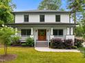 Inviting two-story home with a classic design, featuring a covered front porch and well-maintained yard at 2551 Drake Ave, Durham, NC 27705
