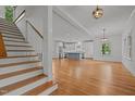 Spacious living room with hardwood floors, open to kitchen, and staircase, perfect for modern living at 2551 Drake Ave, Durham, NC 27705
