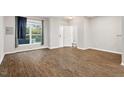 Bright living room with hardwood floors, a large window, and an entry doorway at 330 Gilman Ln # 109, Raleigh, NC 27610