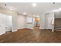 Spacious living room with hardwood floors connecting to the kitchen and stairs at 330 Gilman Ln # 109, Raleigh, NC 27610