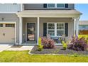 Inviting front porch with stylish seating and landscaping enhancing curb appeal at 341 Henry Steel Dr, Gibsonville, NC 27249