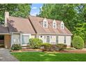 Close-up view of a charming home with a manicured lawn and a dormer window at 3705 Old Post Rd, Raleigh, NC 27612