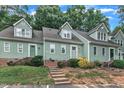 Charming townhouse exterior showcasing well-maintained landscaping and a welcoming entrance with inviting stairs and white railing at 410 Oak Run Dr, Raleigh, NC 27606