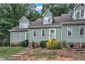 The exterior shows a townhouse with concrete steps, and lovely foliage, and a nicely manicured lawn with shrubbery at 410 Oak Run Dr, Raleigh, NC 27606