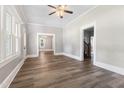 Bright living area with wood-look floors and large windows allowing ample natural light at 413 E Center St, Nashville, NC 27856