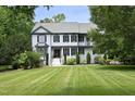 A charming two-story home with a landscaped yard featuring a well-manicured lawn and lush greenery at 4217 Grahamstone Rd, Raleigh, NC 27610