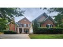 Attractive brick home with a manicured lawn, featuring a two-car garage and a welcoming front entrance at 502 Willowmere Ct, Cary, NC 27513