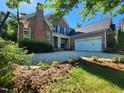 Beautiful brick home with a well-manicured lawn and a spacious driveway with a basketball hoop at 502 Willowmere Ct, Cary, NC 27513