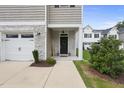 Inviting front porch with stone accents and a charming 'Welcome' sign enhances curb appeal at 511 Kenton Mill Ct, Rolesville, NC 27571