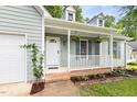 Inviting front porch with a white railing and a well-maintained garden at 522 Johnson St, Garner, NC 27529
