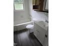 Clean bathroom with tiled walls, a white vanity, and a tub/shower combination at 704 N King Charles Rd, Raleigh, NC 27610