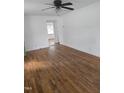 Spacious room featuring hardwood floors, fresh paint, and ample natural light streaming through the windows at 704 N King Charles Rd, Raleigh, NC 27610