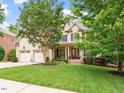 Charming two-story home with a well-manicured lawn and attached two-car garage at 7906 Longleaf Branch Ct, Raleigh, NC 27612