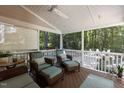 Relaxing covered patio with ceiling fan and comfortable seating overlooking lush greenery at 8004 Gabriels Bend Dr, Raleigh, NC 27612