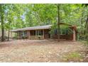 Quaint single-story brick home featuring traditional shutters and a welcoming front porch surrounded by mature trees at 809 Valerie Dr, Raleigh, NC 27606