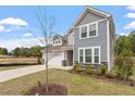Beautiful home with a long drive way with lush landscape and grey concrete at 815 Harmony Ranch Ln, Franklinton, NC 27525