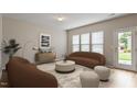 Well-lit living room with cozy seating and access to the outdoors at 107 Tuftin Dr, Durham, NC 27703