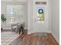 Inviting foyer featuring wood floors, a neutral color palette, and a view of the front door at 1127 Timbercut Dr, Durham, NC 27703
