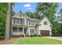Traditional two-story home with a porch, dormers, and attached garage at 117 Garden Oaks Dr, Smithfield, NC 27577