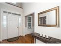 Welcoming foyer with hardwood floors, white door and classic decor at 117 Garden Oaks Dr, Smithfield, NC 27577