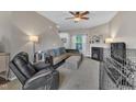 Cozy living room with a fireplace, neutral carpet, and a comfortable sectional sofa at 120 Feezor Ct, Clayton, NC 27527
