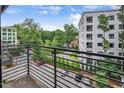 Balcony overlooking parking and greenery, offering a peaceful outdoor retreat with city views at 1300 St Marys St # 402, Raleigh, NC 27605