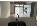 Open kitchen with modern cabinets, sink, sliding doors and natural light at 1300 St Marys St # 402, Raleigh, NC 27605