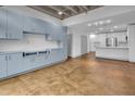 Open living area showcases built-in cabinets and seamlessly connects to a modern, white kitchen at 1300 St Marys St # 402, Raleigh, NC 27605
