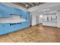 Open-concept living space featuring custom light blue built-in cabinetry and concrete-look floors at 1300 St Marys St # 402, Raleigh, NC 27605