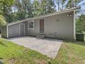 Photo shows the exterior of the home with an entry door and concrete patio at 152 A&B Cedar Terrace, Chapel Hill, NC 27516