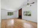 Living room with vaulted ceilings, wood floors, a ceiling fan, and a fireplace at 152 A&B Cedar Terrace, Chapel Hill, NC 27516