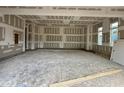 Expansive garage space with unfinished walls, offering potential for customization at 155 Cherry Bark Dr, Youngsville, NC 27596