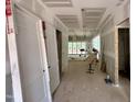 Spacious hallway with unfinished walls leads to the rest of the under-construction house at 155 Cherry Bark Dr, Youngsville, NC 27596