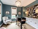 Stylish home office with blue walls, chic chandelier, modern desk, and sophisticated decor for productive work at 1610 Draper View Loop # 101, Raleigh, NC 27608