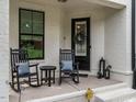 Charming porch with rocking chairs, pillows, and decorative lanterns for a relaxing welcome at 1610 Draper View Loop # 101, Raleigh, NC 27608