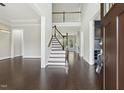 Grand foyer with hardwood floors, soaring ceilings, and an elegant staircase at 1625 Banks View Dr, Raleigh, NC 27603