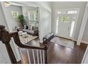 Inviting foyer features a hardwood floor, decorative rug, and a view into the adjacent sitting area at 1625 Banks View Dr, Raleigh, NC 27603