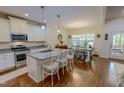 Bright kitchen with a large island, granite countertops, and a dining area with natural light at 167 Sequoia Dr, Timberlake, NC 27583