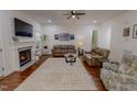 Inviting living room with a cozy fireplace, hardwood floors, and ample seating at 167 Sequoia Dr, Timberlake, NC 27583