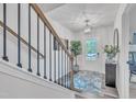 Bright entryway featuring wood floors, elegant staircase, and a stylish light fixture at 1729 Starlit Sky Ln, Cary, NC 27519