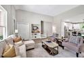 Open-concept living room with modern decor, neutral colors, and ample natural light at 1824 Irish Blvd, Sanford, NC 27332