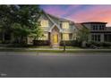 Charming two-story home features a manicured lawn, brick accents, and a welcoming yellow front door at 1962 Briar Chapel Pkwy, Chapel Hill, NC 27516