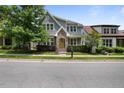 Charming two-story home features a manicured lawn, brick accents, and a welcoming yellow front door at 1962 Briar Chapel Pkwy, Chapel Hill, NC 27516