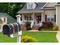 Charming front yard view featuring a mailbox with house number and a well-maintained lawn at 200 Holly Branch Dr, Holly Springs, NC 27540