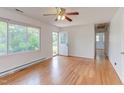 Bright living room with hardwood floors, large window, and access to entry and hallway, creating an open feel at 2009 Carolina Ave, Durham, NC 27705