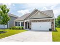 Attractive home with stone detail, a two-car garage, and a welcoming front yard in a neighborhood at 202 E Painted Way, Clayton, NC 27527