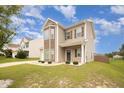 Attractive two-story home with a well-manicured lawn and stylish exterior accents at 2309 King Malcolm Ln, Zebulon, NC 27597