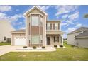 Charming two-story home with attached garage, well-maintained lawn, and appealing curb appeal at 2309 King Malcolm Ln, Zebulon, NC 27597